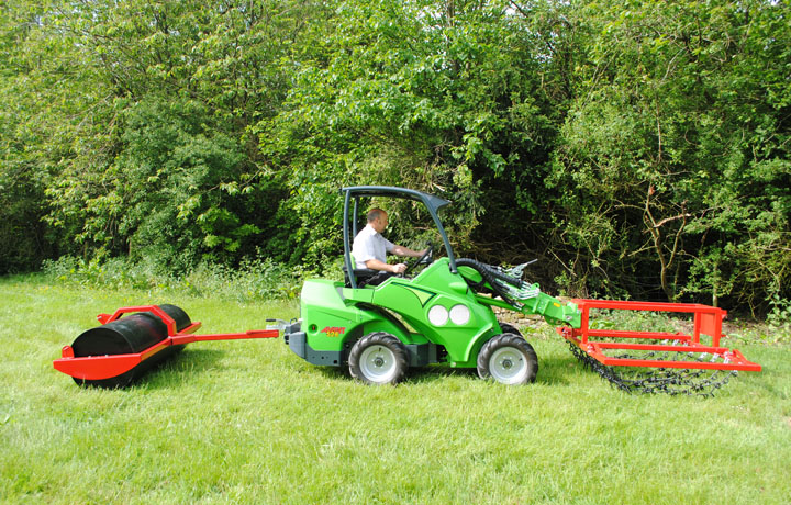 Front mounted chain harrows